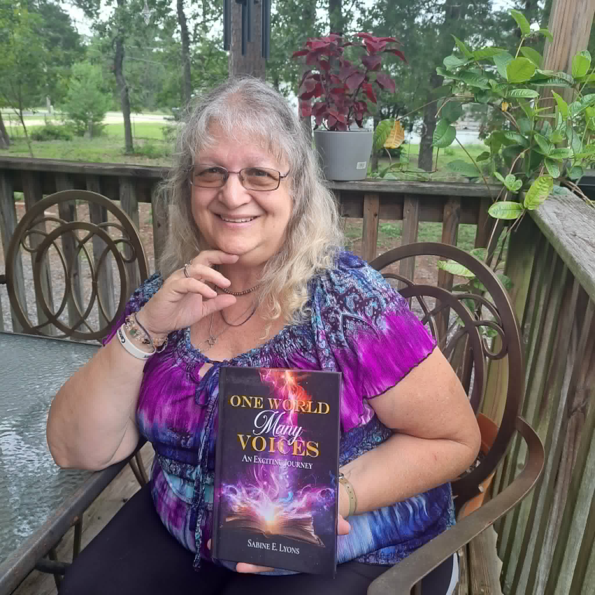 Sabine Lyons with her book "One World, Many Voices"